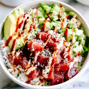 Cozy spicy tuna poke bowl with fresh ingredients and vibrant garnishes.