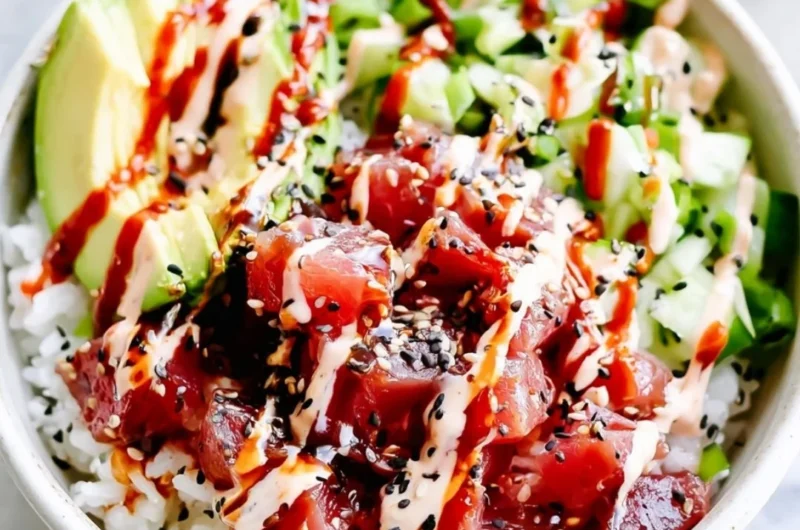 Cozy spicy tuna poke bowl with fresh ingredients and vibrant garnishes.