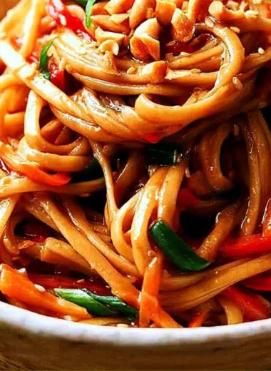 Bowl of easy Thai noodles topped with creamy peanut sauce and vegetables