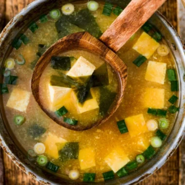 Bowl of homemade miso soup with tofu and green onions garnished