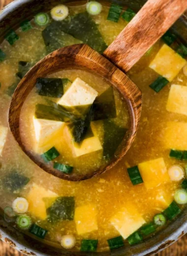 Bowl of homemade miso soup with tofu and green onions garnished