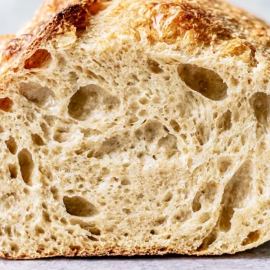 Freshly baked sourdough bread loaf on a wooden table