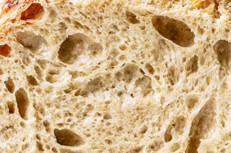 Freshly baked sourdough bread loaf on a wooden table