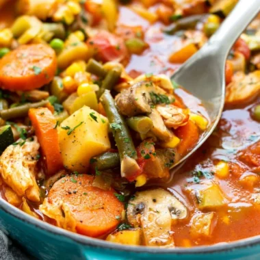 A bowl of homemade chicken vegetable soup with fresh ingredients
