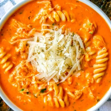 Crockpot Chicken Parmesan Soup served in a bowl with herbs on top