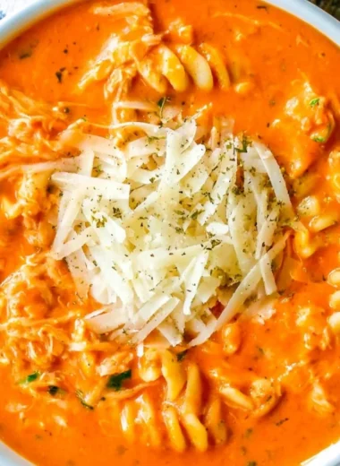 Crockpot Chicken Parmesan Soup served in a bowl with herbs on top