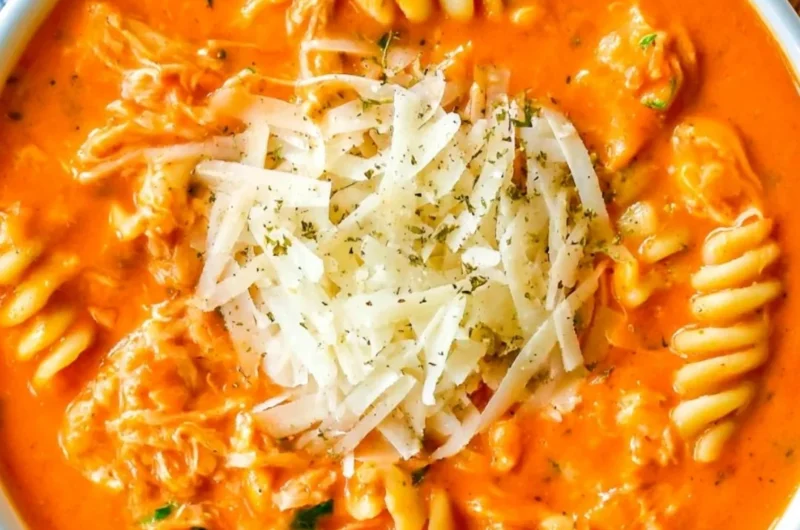 Crockpot Chicken Parmesan Soup served in a bowl with herbs on top