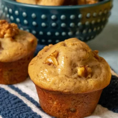 Freshly baked banana nut muffins on a wooden table