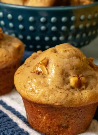 Freshly baked banana nut muffins on a wooden table
