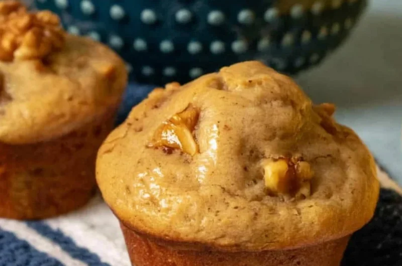 Freshly baked banana nut muffins on a wooden table