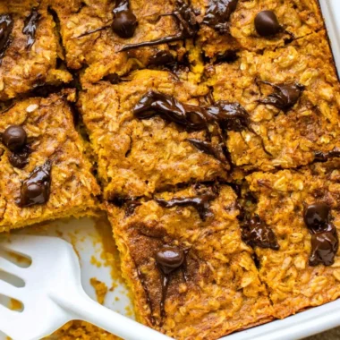 A bowl of pumpkin baked oatmeal topped with chocolate chips and spices