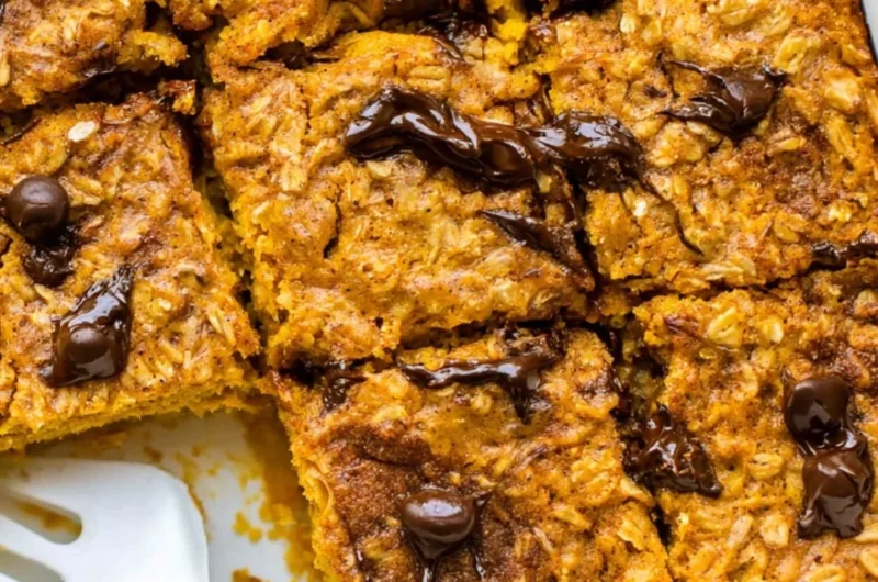 A bowl of pumpkin baked oatmeal topped with chocolate chips and spices