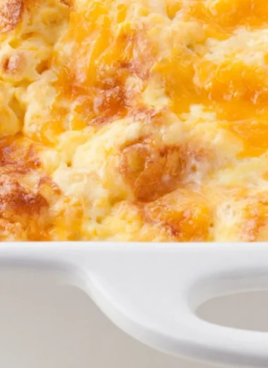 Oven scrambled egg and cheese bake casserole on a plate, ready to serve for breakfast.