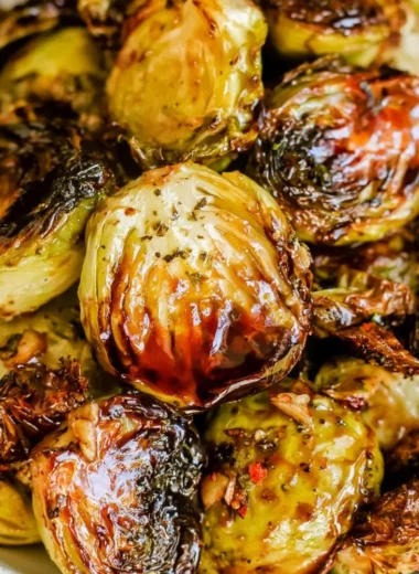 Roasted Brussels sprouts with honey balsamic sauce on a serving plate