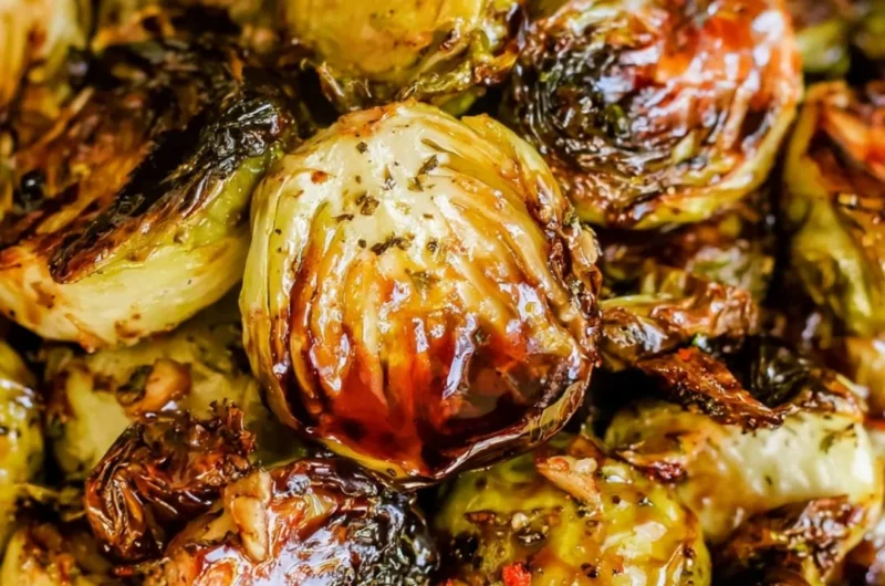 Roasted Brussels sprouts with honey balsamic sauce on a serving plate