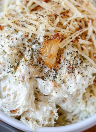 Creamy roasted garlic dip served with fresh vegetables and toasted bread.