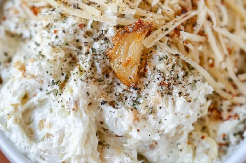 Creamy roasted garlic dip served with fresh vegetables and toasted bread.