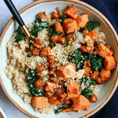 Vegan sweet potato grain bowls topped with almond dressing, fresh and colorful ingredients.
