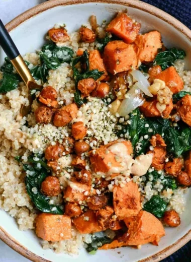 Vegan sweet potato grain bowls topped with almond dressing, fresh and colorful ingredients.
